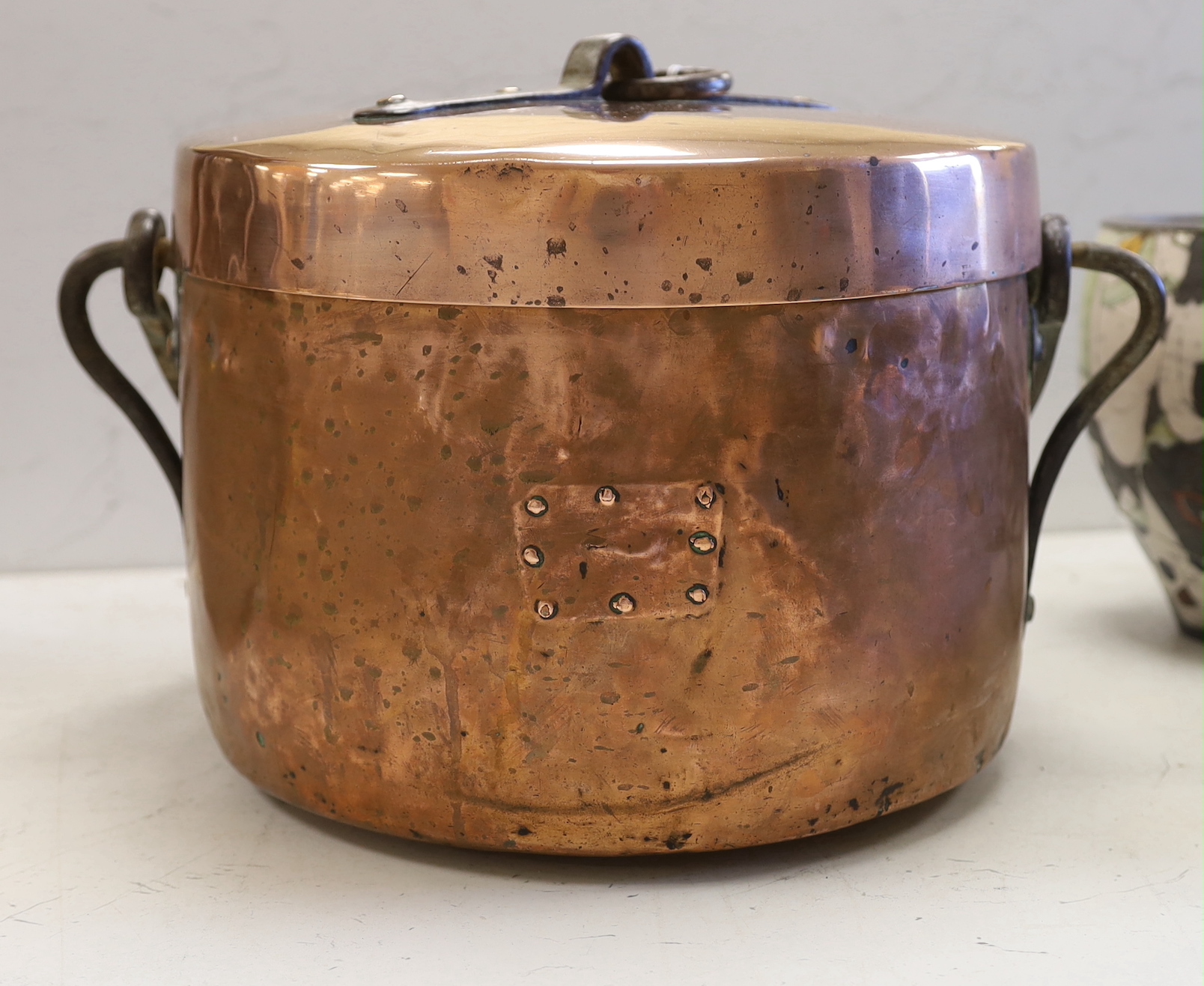 A French copper cooking pot and cover with swing handle, 27cm high